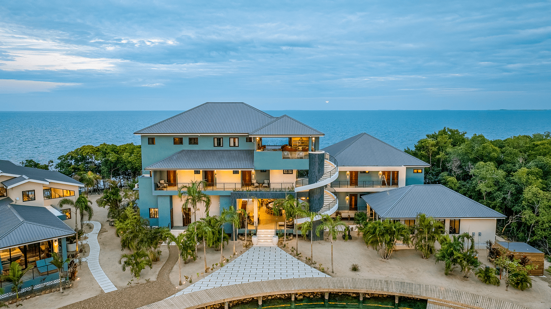 Modern beachfront villa with lush landscaping and ocean views.